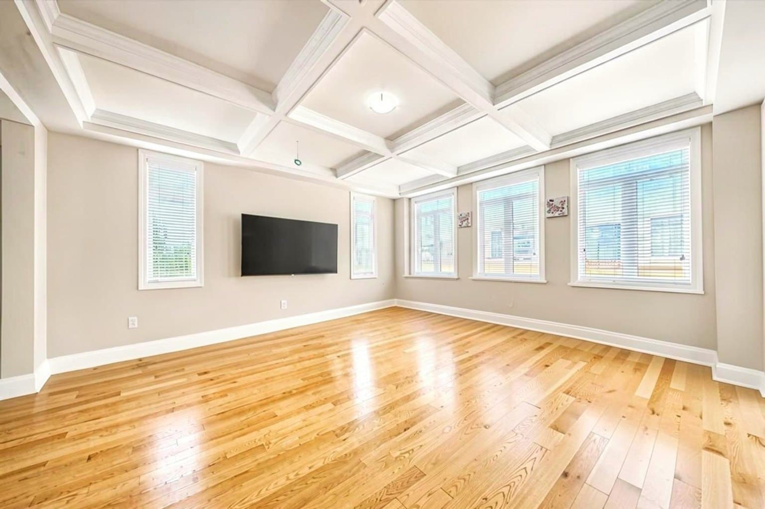 Living Room listing photo after AI furniture removal — toys & playpen cleared, room untouched