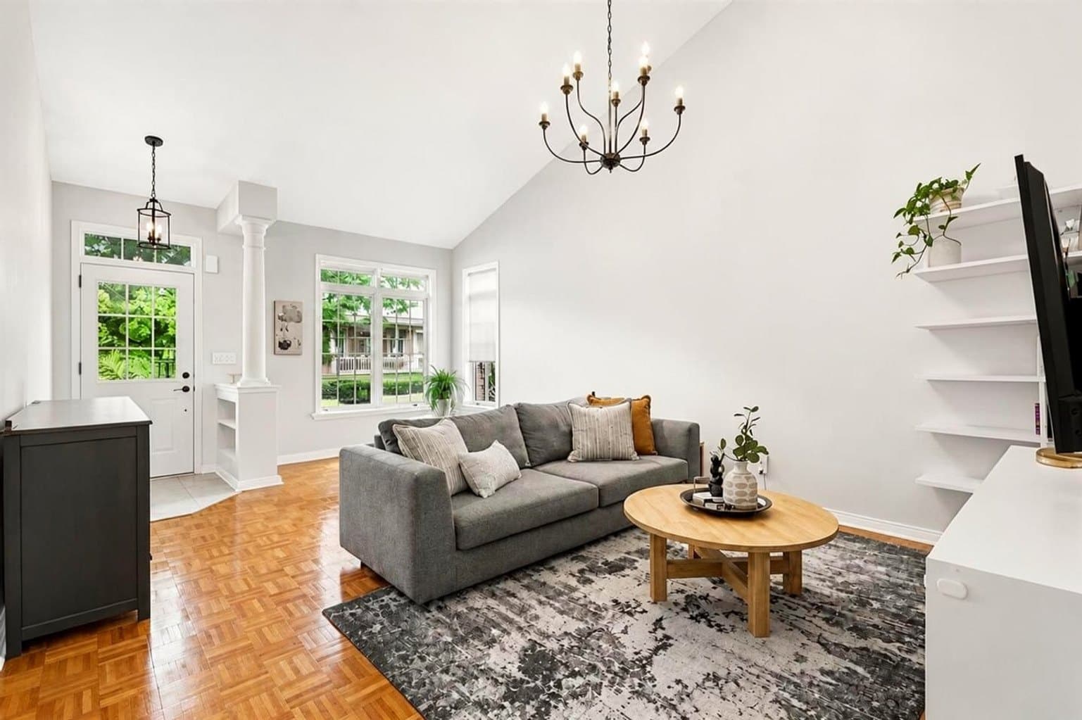 Living Room listing photo after AI furniture removal — gallery wall & piano cleared, room untouched
