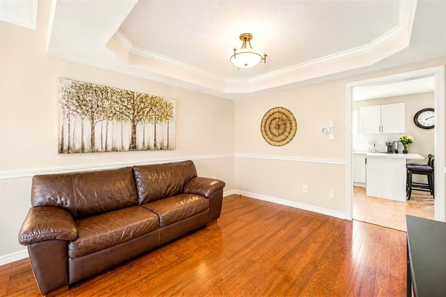 Living Room listing photo after AI furniture removal — armchair, ottoman & lamps cleared, room untouched