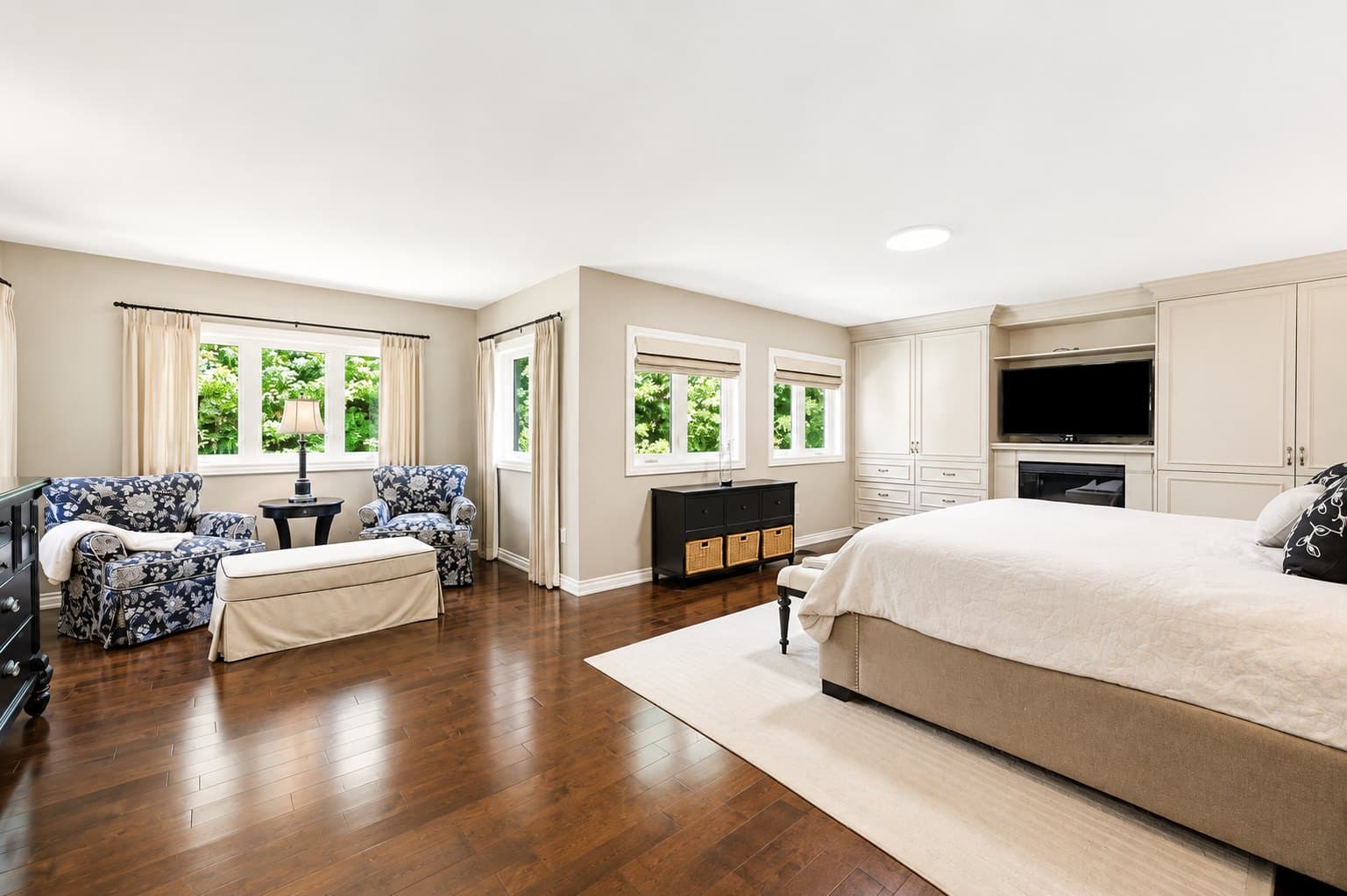 Primary Bedroom listing photo before AI furniture removal — sitting area & dresser still in the room