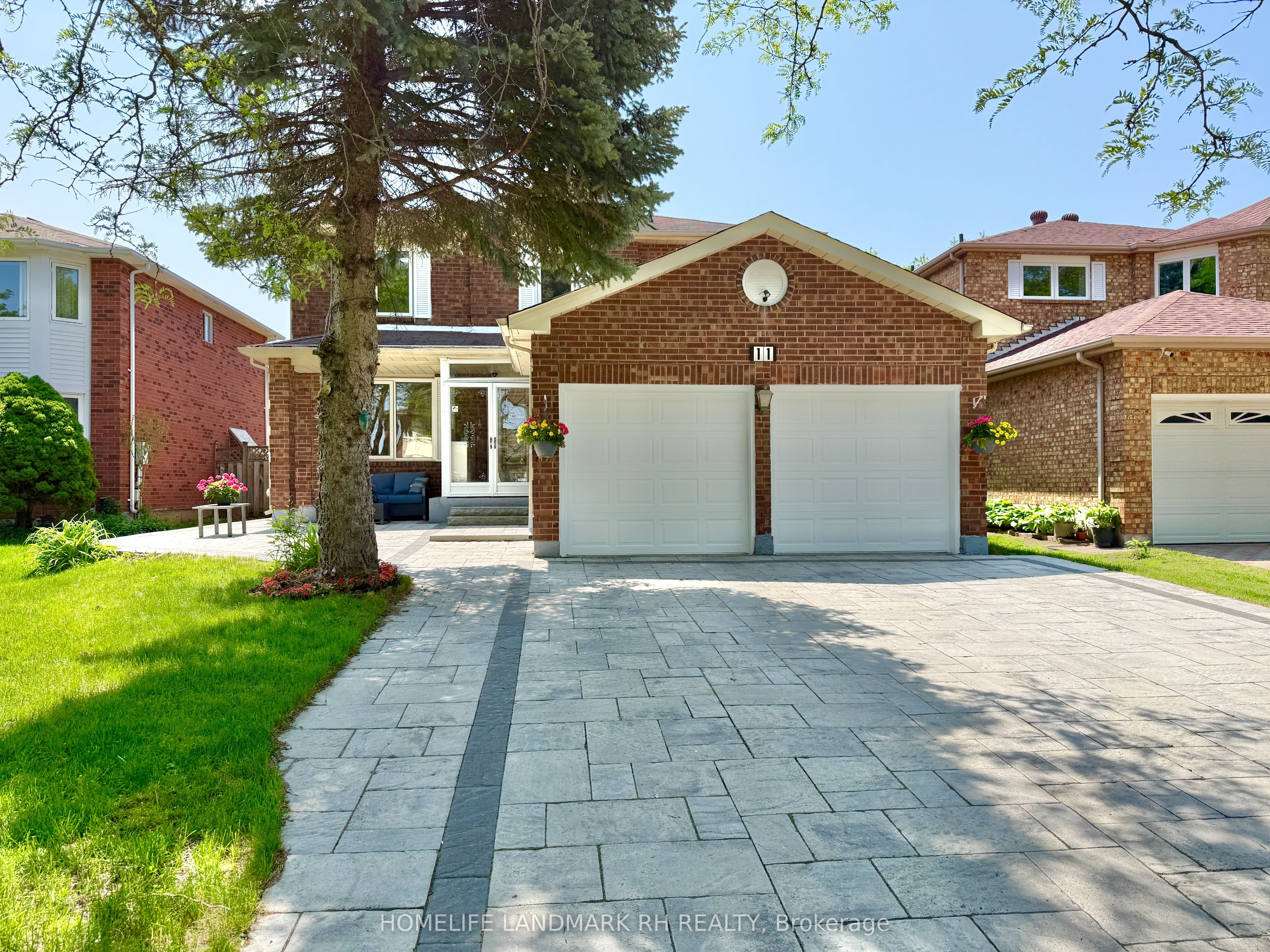 Beautiful brick house with well-maintained landscaping and paved driveway - Property Sold